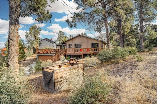 back of house with a deck