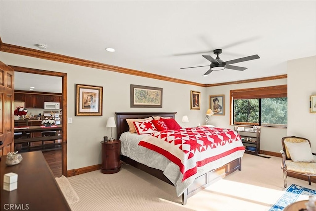 carpeted bedroom with baseboards, ornamental molding, and ceiling fan