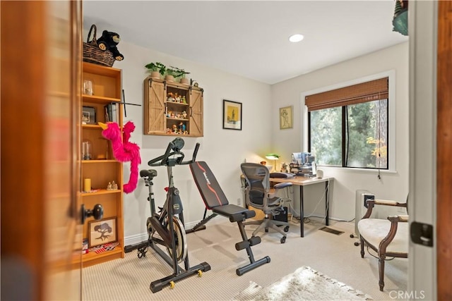 workout room with baseboards and carpet
