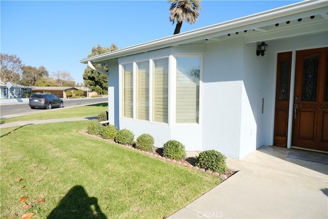 view of side of property with a yard