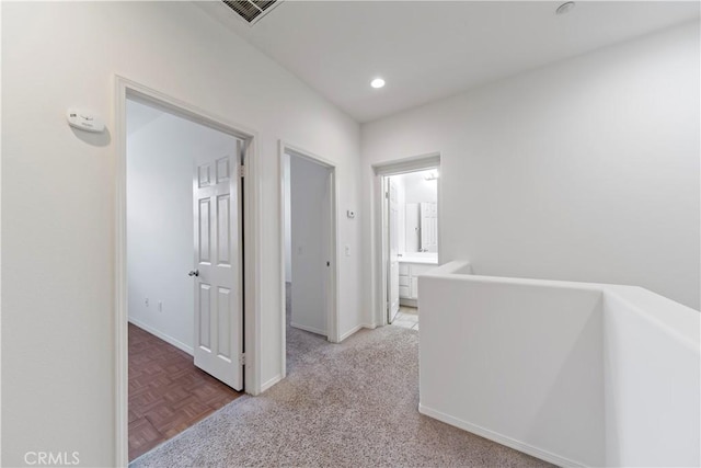 hall featuring recessed lighting, visible vents, and baseboards