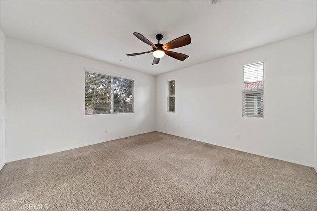 carpeted empty room with ceiling fan