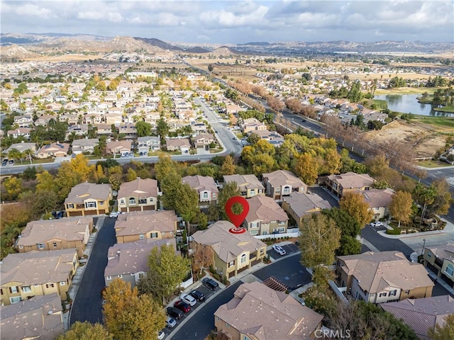 drone / aerial view with a water view and a residential view