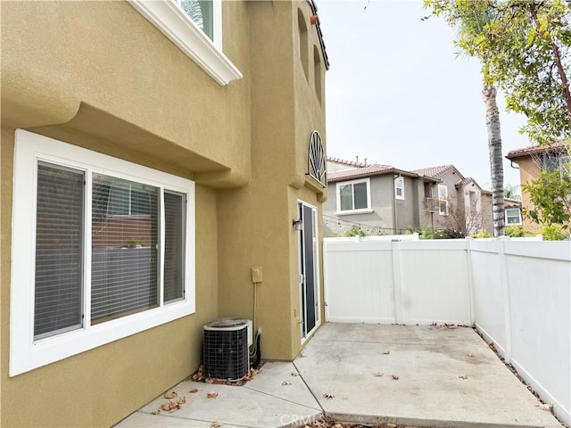 view of patio / terrace featuring central AC and fence