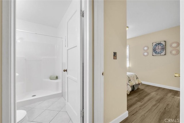 bathroom with a shower and hardwood / wood-style flooring