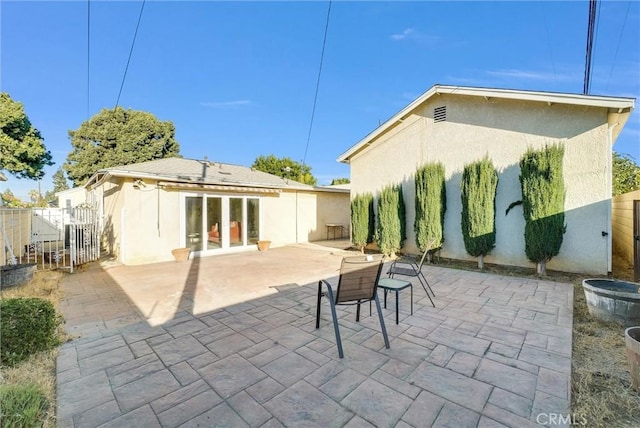 rear view of property featuring french doors and a patio