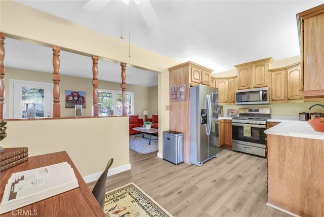 kitchen with light brown cabinets, stainless steel appliances, light hardwood / wood-style floors, and sink