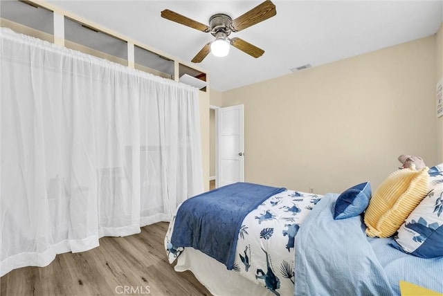 bedroom featuring ceiling fan and light wood-type flooring