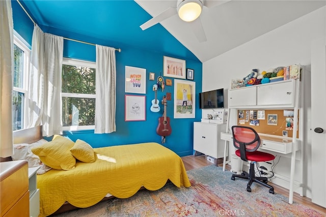 bedroom with hardwood / wood-style flooring, vaulted ceiling, and ceiling fan