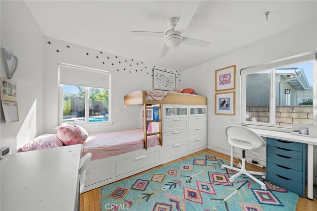 bedroom with ceiling fan and light hardwood / wood-style flooring