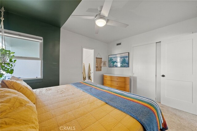 bedroom with carpet, a closet, and ceiling fan