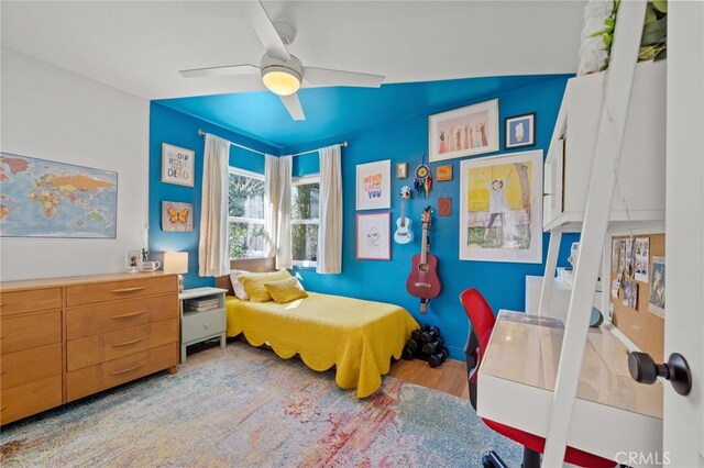 bedroom featuring light wood-type flooring and ceiling fan