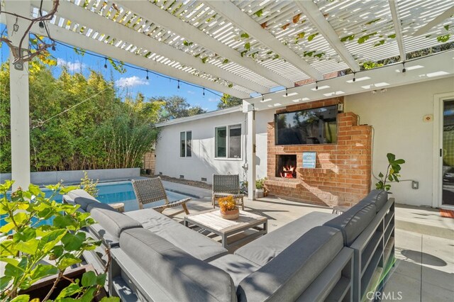 view of patio with a pergola and an outdoor living space with a fireplace