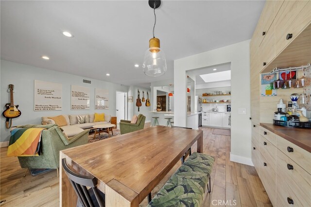 dining space with light hardwood / wood-style flooring