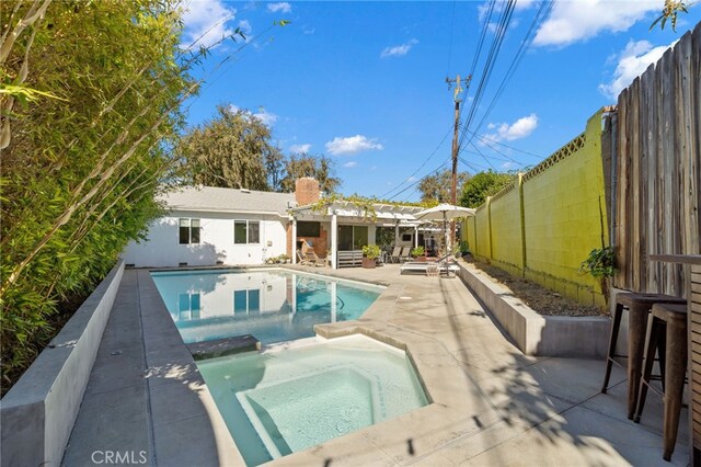 view of pool featuring an in ground hot tub and a patio