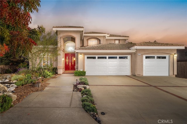 mediterranean / spanish-style home featuring a garage