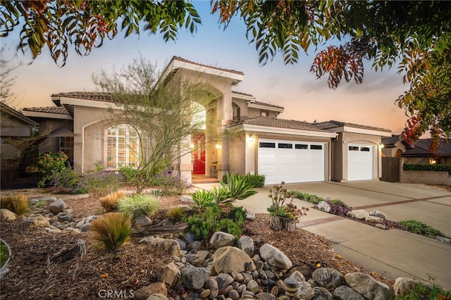 mediterranean / spanish home featuring a garage