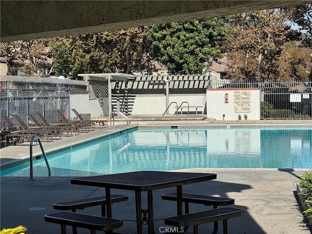 view of swimming pool with a patio area