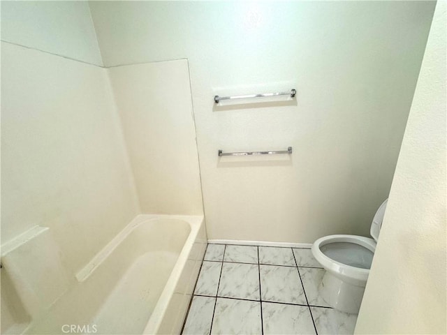 bathroom with a tub and toilet