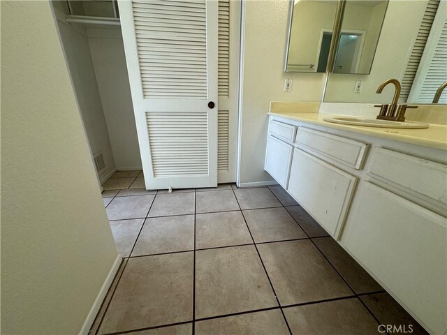72 Brownfield Ln, Pomona, CA 91766 - bathroom with tile patterned flooring, vanity, and baseboards