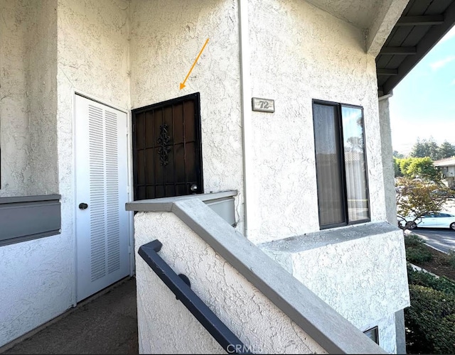 entrance to property with stucco siding