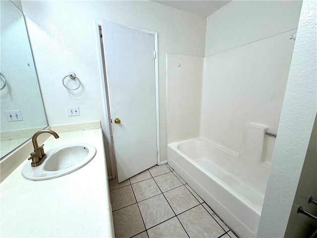 bathroom with tile patterned floors, vanity, and shower / washtub combination