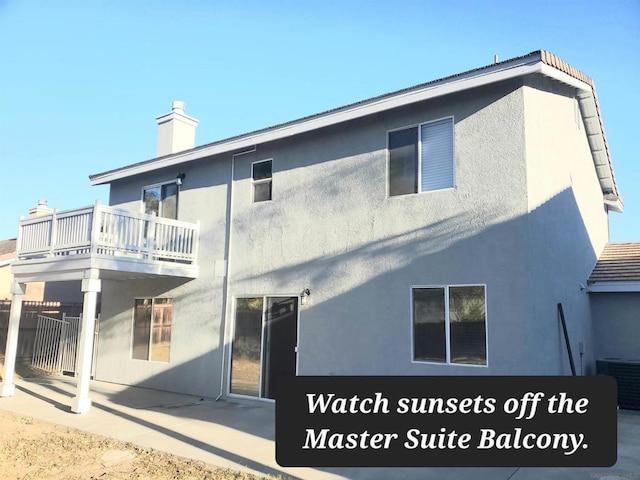 rear view of house featuring a patio, a balcony, and central AC unit