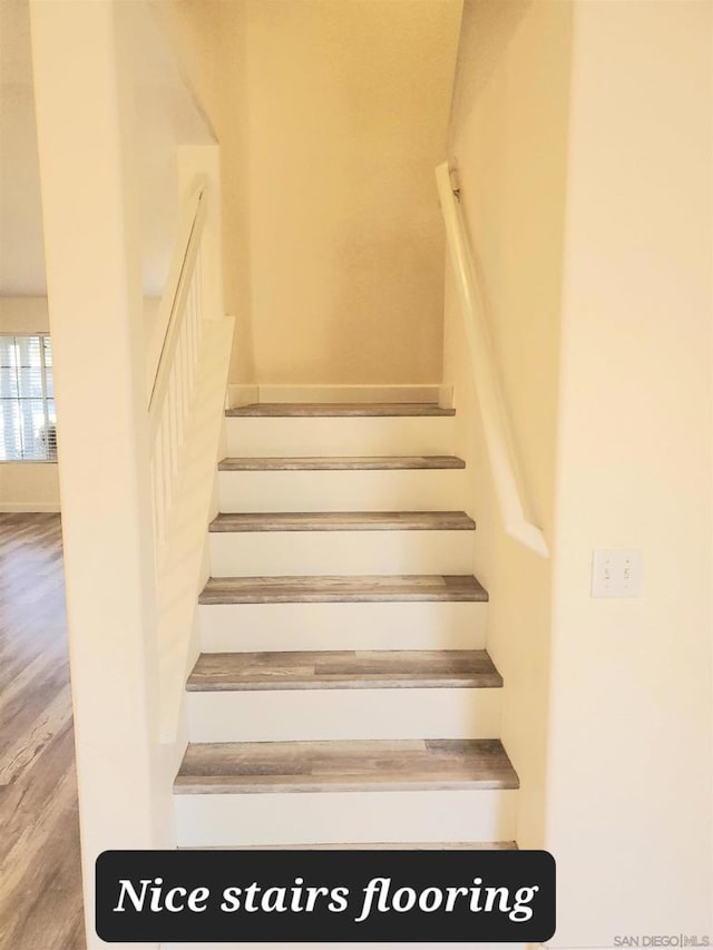 stairs featuring hardwood / wood-style flooring