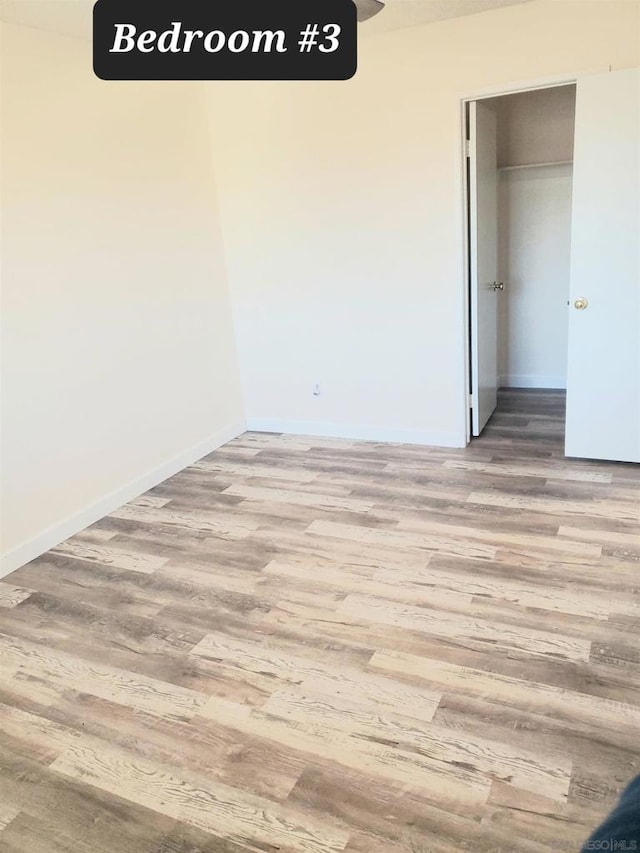 spare room with hardwood / wood-style floors