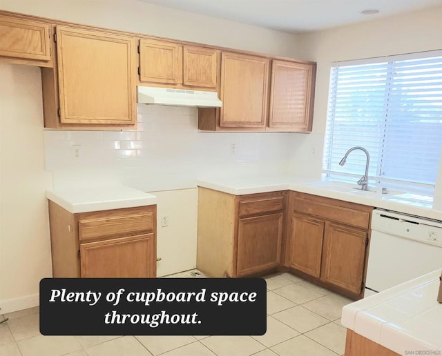 kitchen with dishwasher, decorative backsplash, light tile patterned floors, and sink