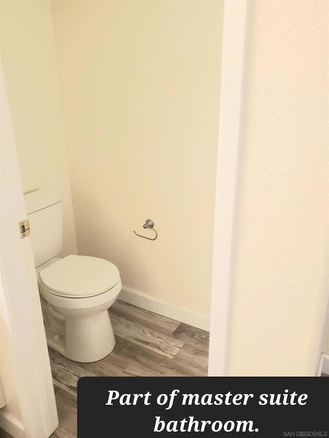 bathroom with wood-type flooring and toilet