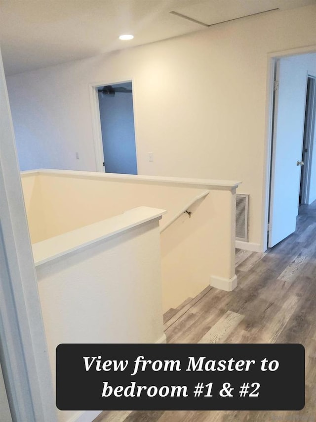 corridor with hardwood / wood-style flooring