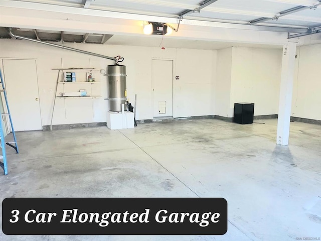 garage featuring strapped water heater and a garage door opener