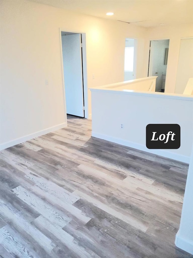 unfurnished room featuring hardwood / wood-style flooring