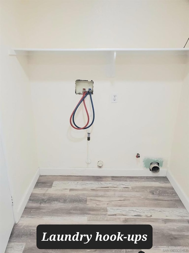 laundry area with hookup for a gas dryer, hardwood / wood-style floors, and washer hookup