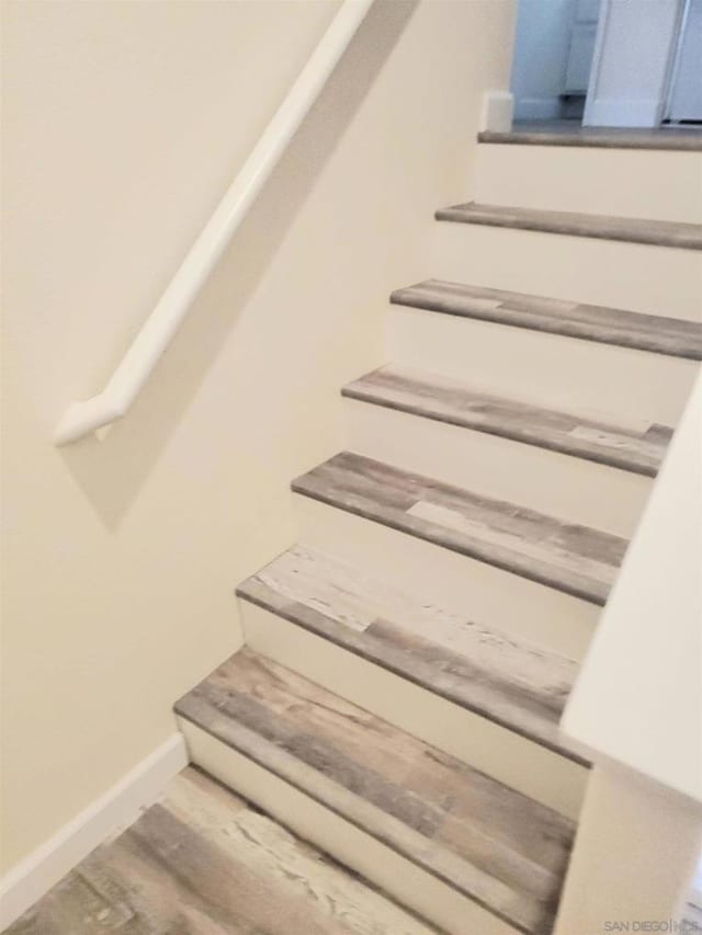 stairway featuring hardwood / wood-style floors