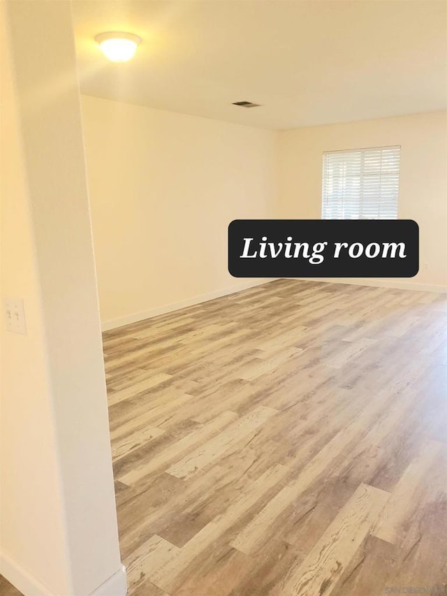 spare room with hardwood / wood-style flooring