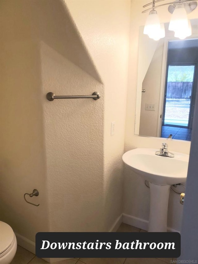 bathroom featuring tile patterned floors and toilet