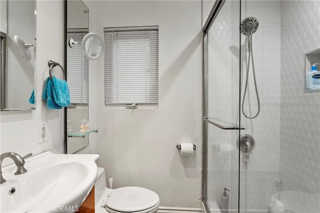 bathroom with vanity, toilet, and an enclosed shower