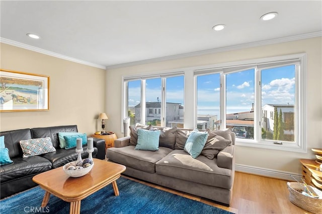 living room featuring a wealth of natural light, hardwood / wood-style floors, and crown molding