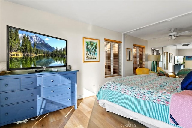 bedroom with ceiling fan, a closet, and light wood-type flooring