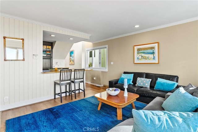 living room featuring wooden walls, hardwood / wood-style floors, and ornamental molding