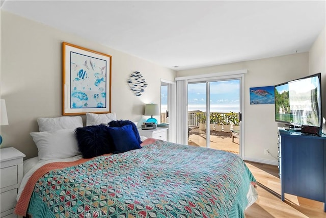 bedroom featuring light hardwood / wood-style floors and access to outside