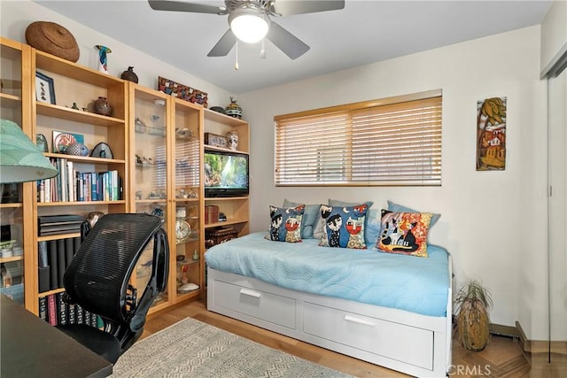 bedroom with ceiling fan and light hardwood / wood-style floors