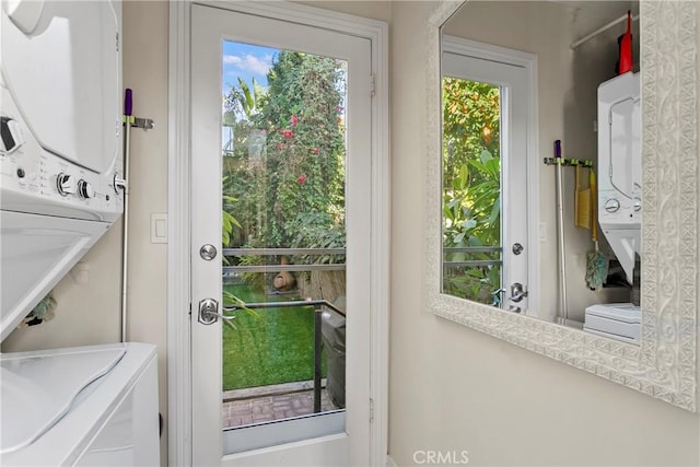 entryway featuring stacked washer / drying machine