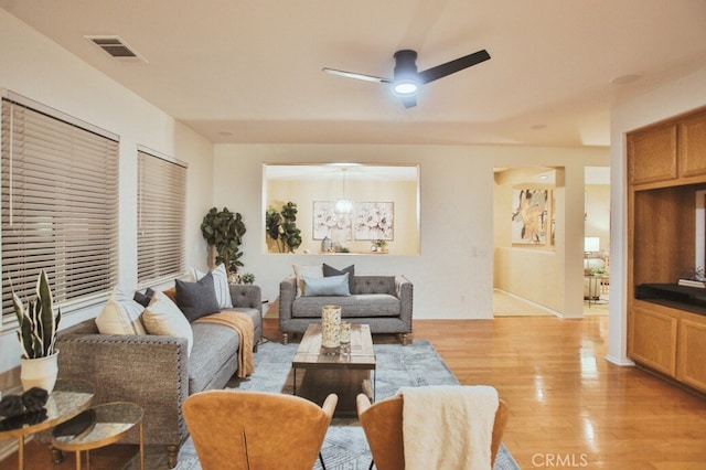 living room featuring ceiling fan and light hardwood / wood-style floors