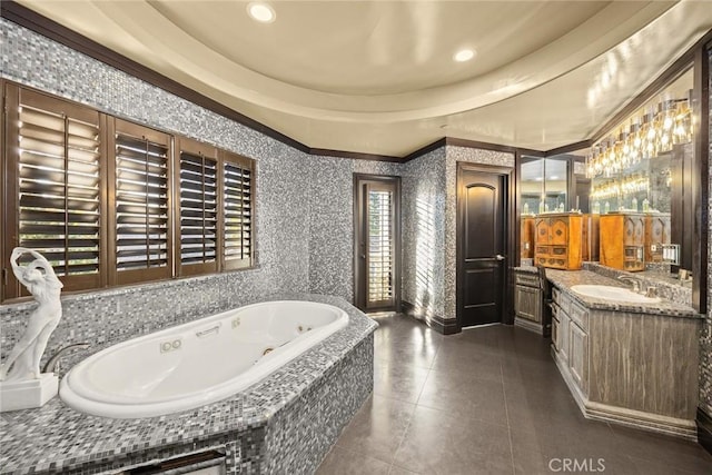 bathroom with tile patterned floors, vanity, ornamental molding, and tiled bath