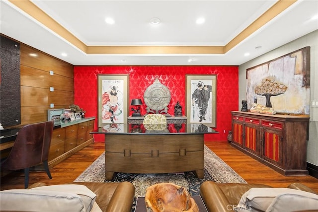 interior space featuring wood-type flooring and a tray ceiling