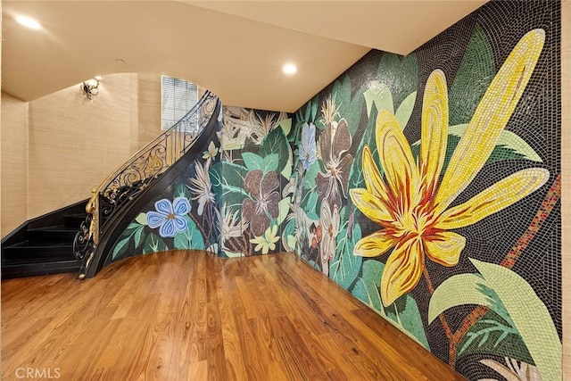 stairway featuring hardwood / wood-style flooring and vaulted ceiling