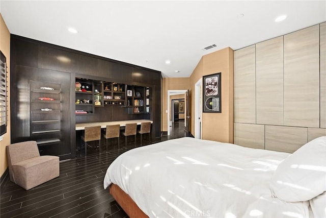 bedroom with dark hardwood / wood-style flooring